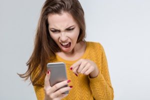 angry woman screaming at smart phone