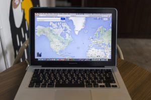 map of world on laptop for business owner looking to reach local customers