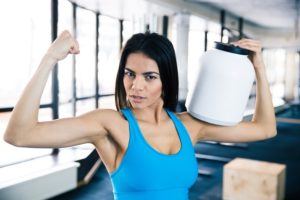 Fit woman showing her muscles ready to optimize website