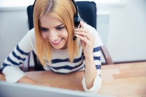Customer female operator in headset giving online customer service