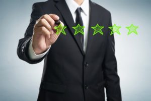 customer filling in online review, leaving star review for business